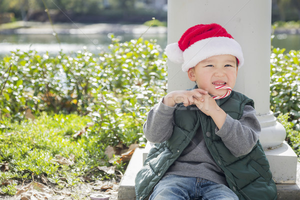 Cute Mixed Race Boy With Santa Hat and Candy Cane Stock photo © feverpitch