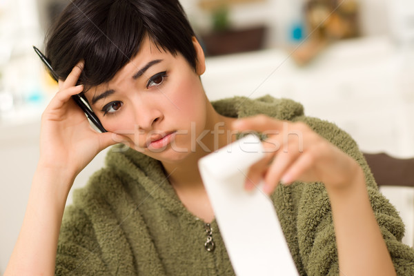 Stock photo: Multi-ethnic Young Woman Agonizing Over Financial Calculations
