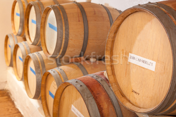 Wine Barrels and Bottles Age Inside Dark Cellar. Stock photo © feverpitch