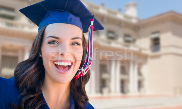 Happy Graduating Mixed Race Woman In Cap and Gown Celebrating on Stock photo © feverpitch