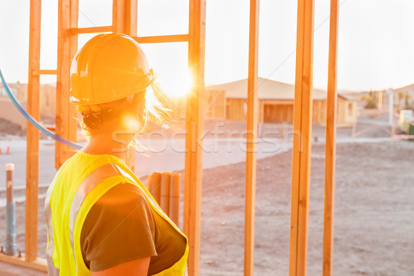 Female Construcion Worker Looking Out From New Home Framing Stock photo © feverpitch