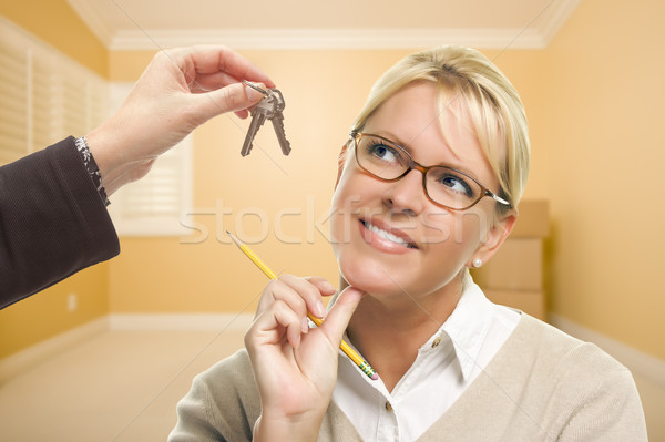 Woman Being Handed Keys in Empty Room with Boxes Stock photo © feverpitch