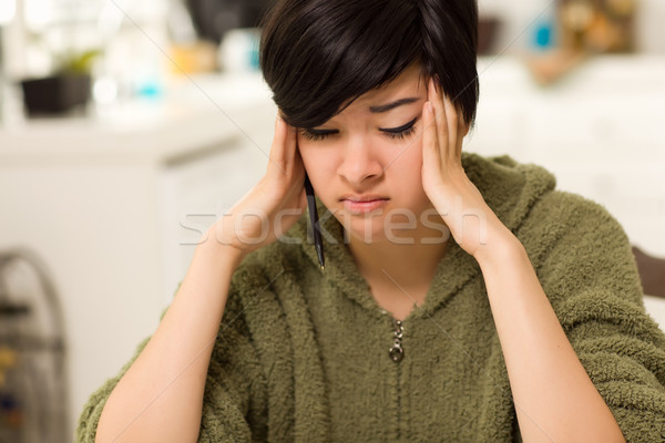 Multi-ethnic Young Woman Rubbing Her Temples Stock photo © feverpitch