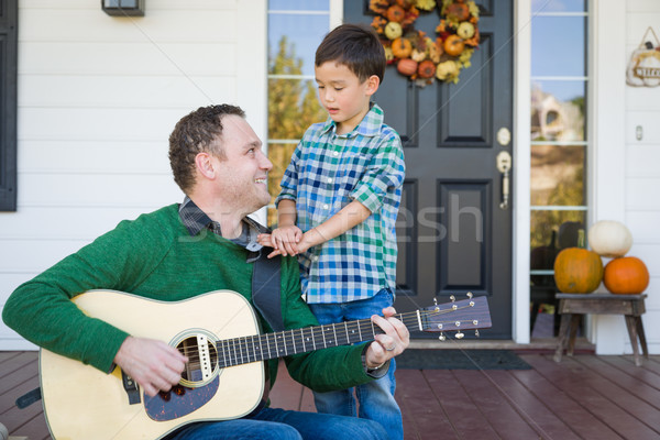 Young Mixed Race Chinese and Caucasian Son Singing Songs and Pla Stock photo © feverpitch