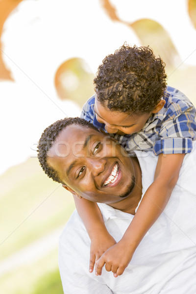 Mixed Race Father and Son Playing Piggyback in Park Stock photo © feverpitch