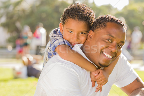 Mixed Race Father and Son Playing Piggyback in Park Stock photo © feverpitch