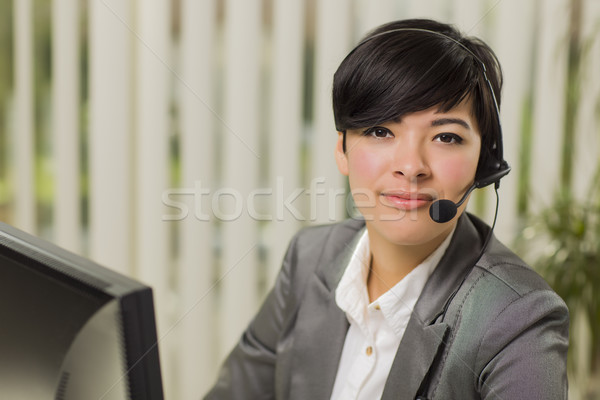 Stock photo: Attractive Young Mixed Race Woman Smiles Wearing Headset