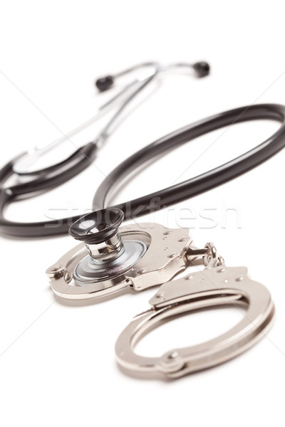Stethoscope and Handcuffs on White Stock photo © feverpitch