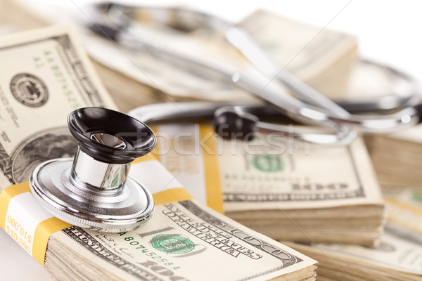 Stethoscope Laying on Stacks of Money Stock photo © feverpitch