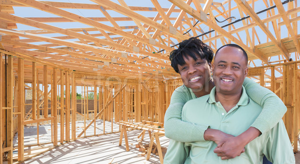Happy African American Couple Inside Construction Framing of New Stock photo © feverpitch
