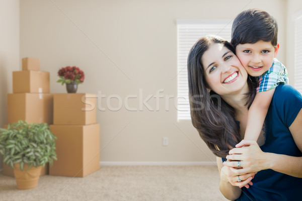 Stock photo: Young Mother and Son Inside Empty Room with Moving Boxes.