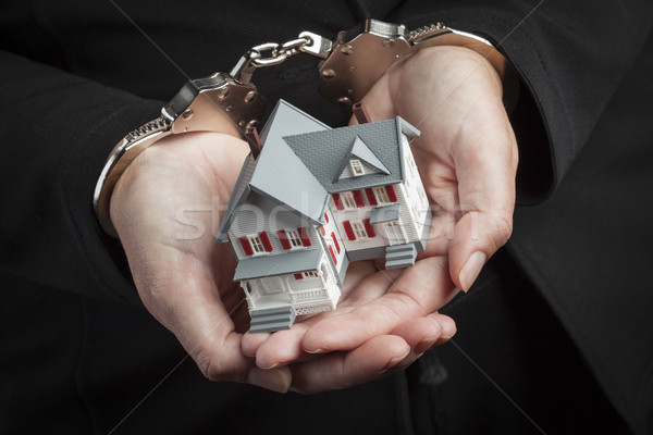 Woman In Handcuffs Holding Small House Stock photo © feverpitch