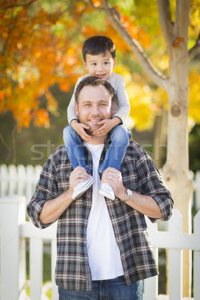 Mixed Race Boy Riding Piggyback on Shoulders of Caucasian Father Stock photo © feverpitch