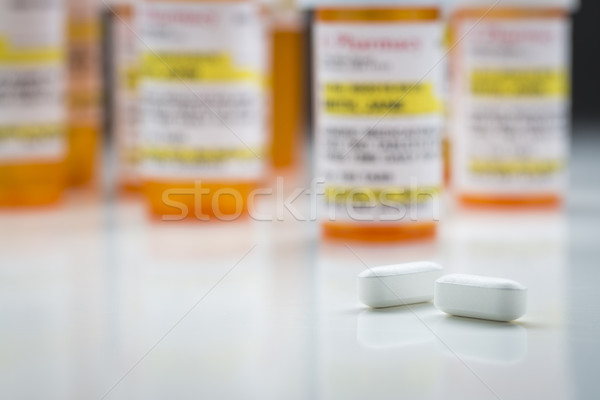 Medicine Bottles and Pills on Reflective Surface With Grey Backg Stock photo © feverpitch