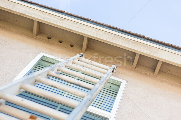 Construction Ladder Leaning Against House Stock photo © feverpitch