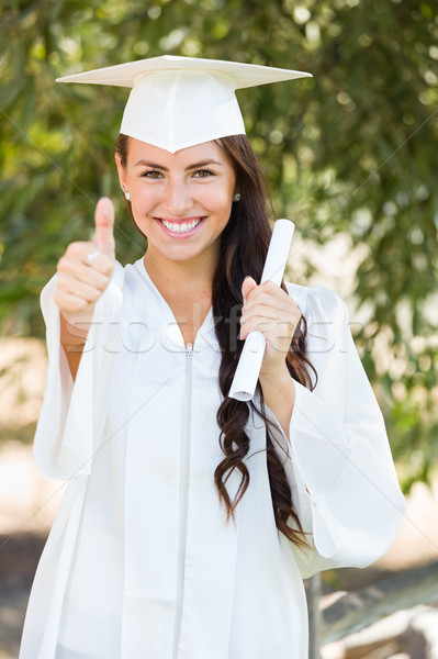 Mixed Race Thumbs Up Girl Celebrating Graduation Outside In Cap  Stock photo © feverpitch