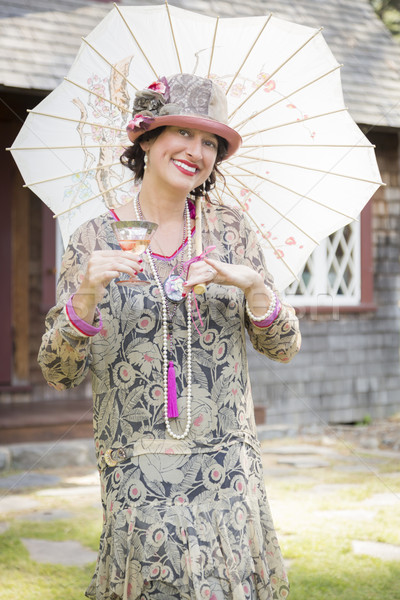 Stock photo: 1920s Dressed Girl with Parasol and Glass of Wine Portrait