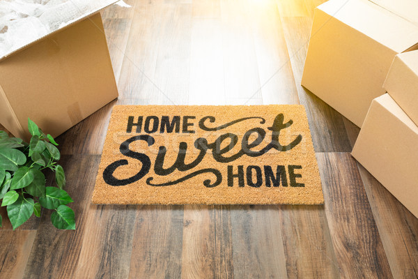 Home Sweet Home Welcome Mat, Moving Boxes and Plant on Hard Wood Stock photo © feverpitch