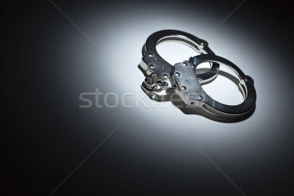 Abstract Pair of Handcuffs Under Spot Light - Text Room Stock photo © feverpitch