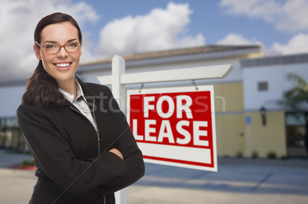 Woman In Front of Commercial Building and For Lease Sign Stock photo © feverpitch