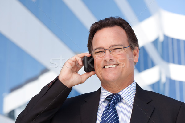Businessman Smiles as He Talks on His Cell Phone Stock photo © feverpitch