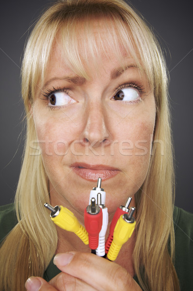 Confused Woman Holding Electronic Cables Stock photo © feverpitch