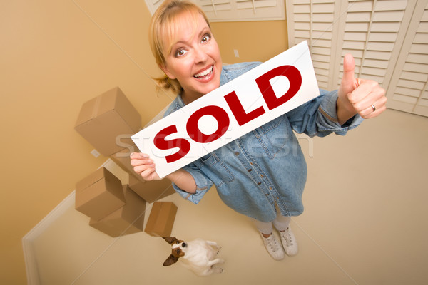 Woman and Doggy with Sold Sign Near Moving Boxes Stock photo © feverpitch
