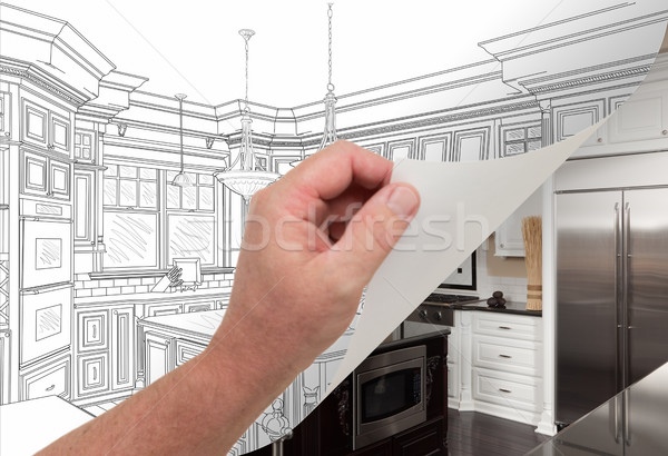Hand Turning Page of Custom Kitchen Drawing to Photograph Stock photo © feverpitch