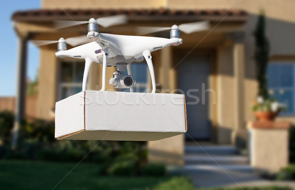 Unmanned Aircraft System (UAV) Quadcopter Drone Delivering Packa Stock photo © feverpitch