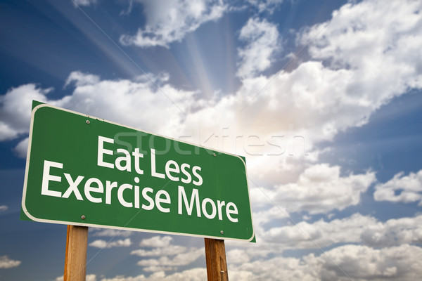 Eat Less Exercise More Green Road Sign and Clouds Stock photo © feverpitch