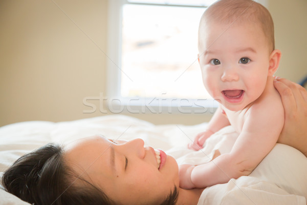 Stock photo: Mixed Race Chinese and Caucasian Baby Boy Laying In Bed with His