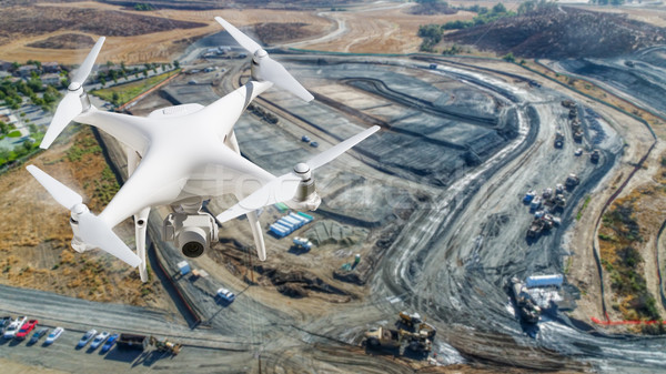 Unmanned Aircraft System (UAV) Quadcopter Drone In The Air Over  Stock photo © feverpitch
