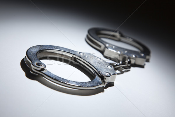 Abstract Pair of Handcuffs Under Spot Light Stock photo © feverpitch