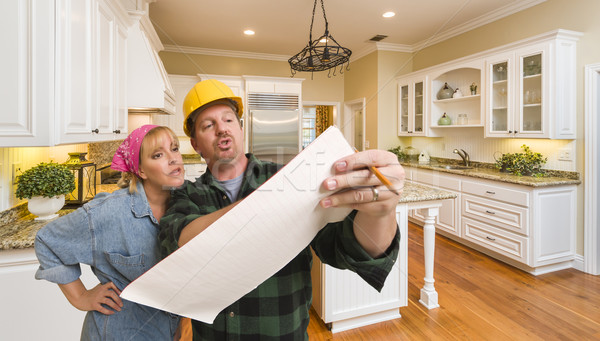 Contractor Discussing Plans with Woman Inside Custom Kitchen Int Stock photo © feverpitch