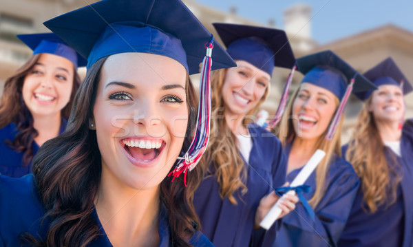 Happy Graduating Group of Girls In Cap and Gown Celebrating on C Stock photo © feverpitch