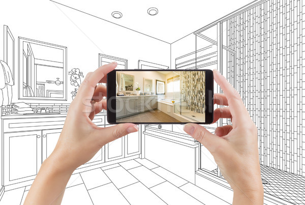 Hands Holding Smart Phone with Master Bathroom Photo on Screen a Stock photo © feverpitch