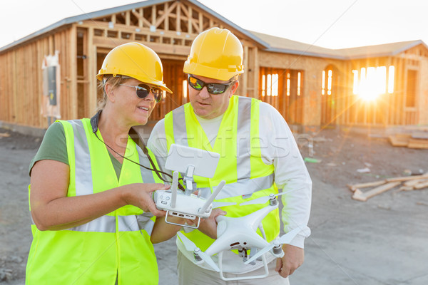 Workers with Drone Quadcopter Inspecting Photographs on Controll Stock photo © feverpitch