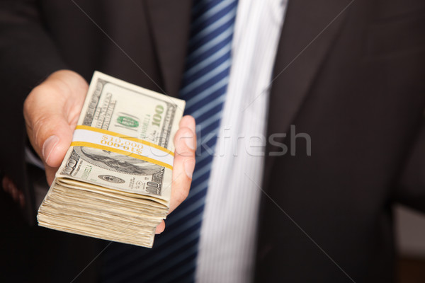 Businessman Handing Over Stack of Cash Stock photo © feverpitch