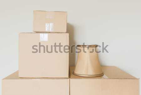 Stock photo: Variety of Packed Moving Boxes In Empty Room