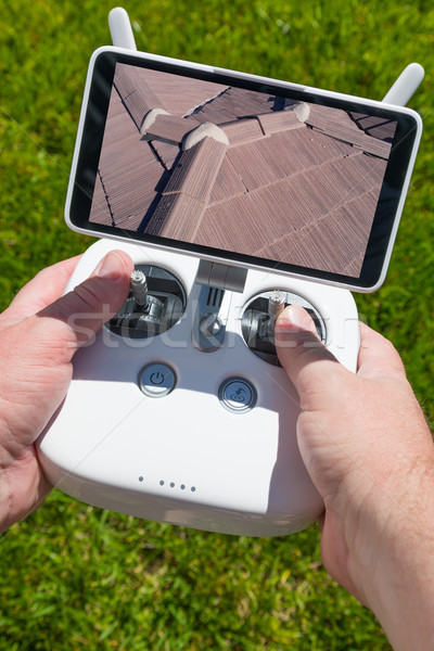 Hands Holding Drone Quadcopter Controller With Residential Roof  Stock photo © feverpitch