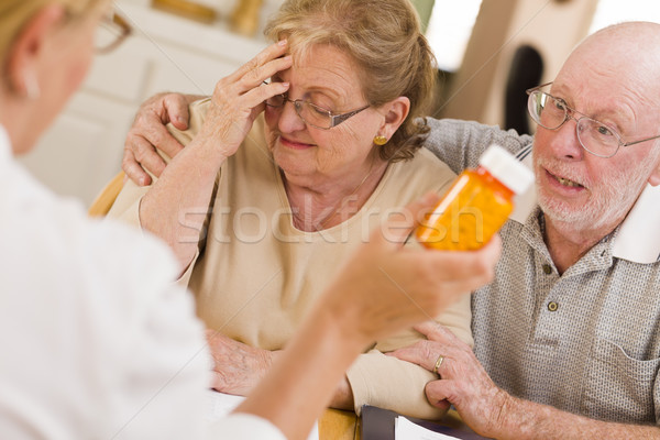 Doctor or Nurse Explaining Prescription Medicine to Senior Coupl Stock photo © feverpitch