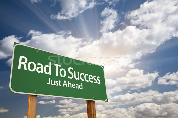 Road To Success Green Road Sign Over Clouds Stock photo © feverpitch