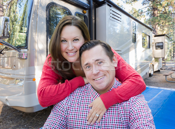 Happy Caucasian Couple In Front of Their Beautiful RV At The Cam Stock photo © feverpitch
