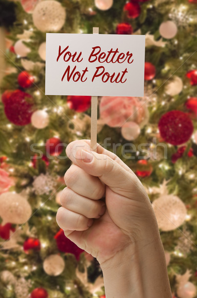 Hand Holding You Better Not Pout Card In Front of Decorated Chri Stock photo © feverpitch