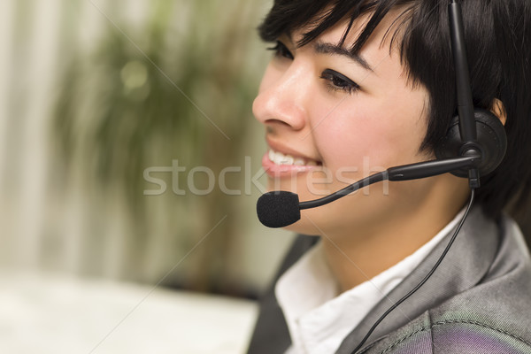 Attractive Young Mixed Race Woman Smiles Wearing Headset Stock photo © feverpitch