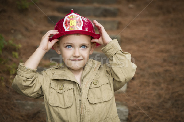 Adorable Child Boy with Fireman Hat Playing Outside Stock photo © feverpitch