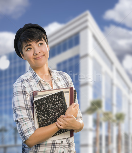 Mixed Race Female Student Holding Books in Front of Building Stock photo © feverpitch