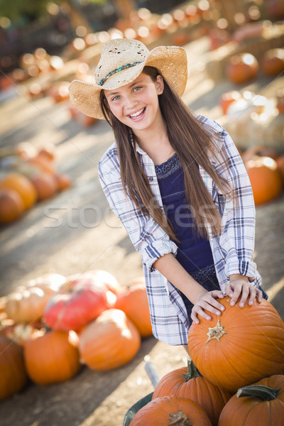 Stock photo: Preteen Girl Playing with a Wheelbarrow at the Pumpkin Patch
