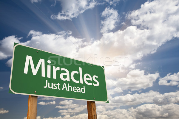 Miracles Green Road Sign Against Clouds Stock photo © feverpitch