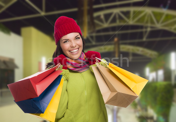 Warmly Dressed Mixed Race Woman with Shopping Bags Stock photo © feverpitch